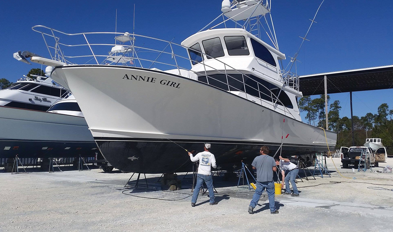 Men cleaning a large Resmondo boat