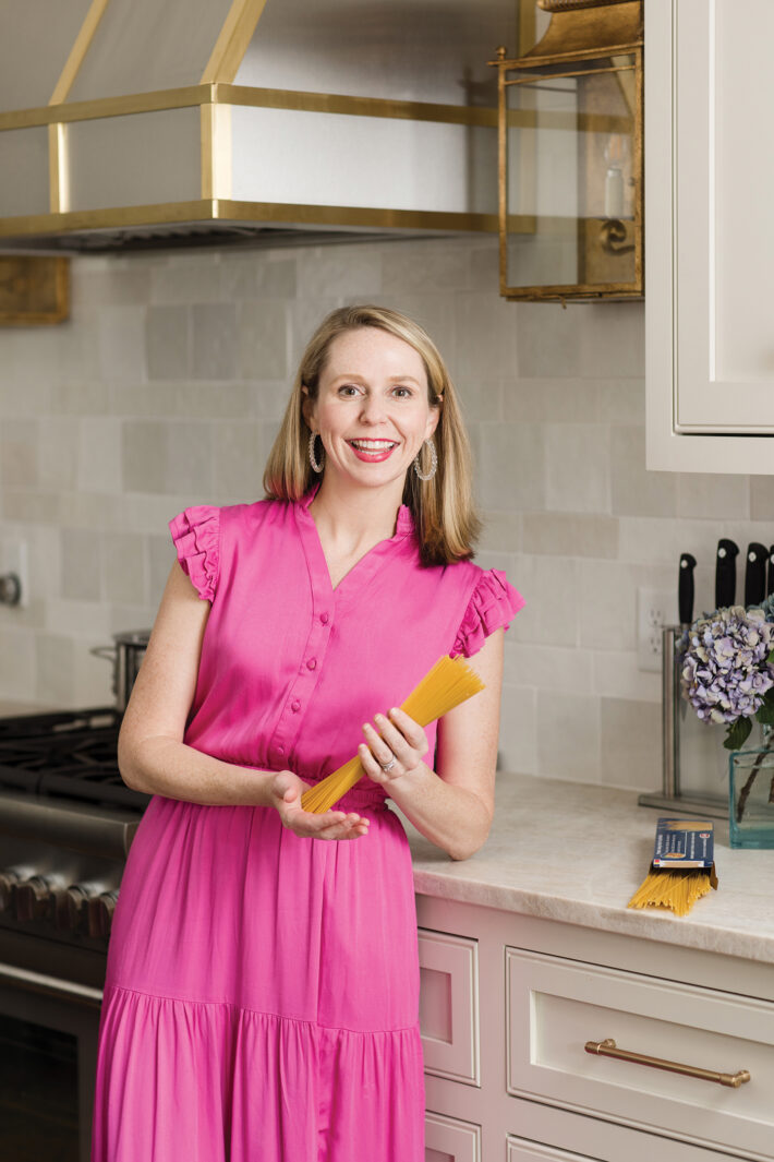 Julie Shreve in her kitchen holding spaghetti
