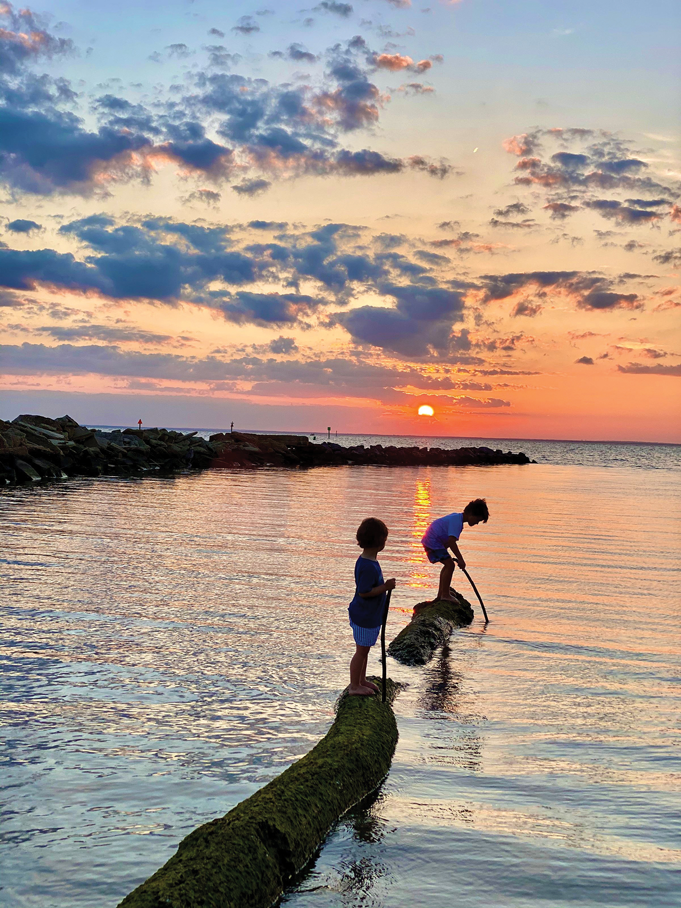 two little boys watching the sunset on Mobile Bay